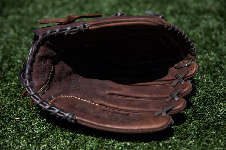 Brown palm of a Player Preferred softball glove lying on a field - SKU: P140BPS