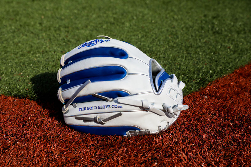 Back of a white/royal Rawlings Liberty Advanced Color Series infield glove on a field - SKU: RLA715SB-31WRP