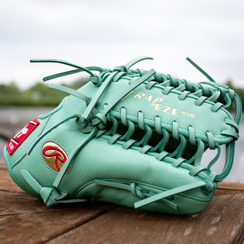 Picture of an ocean mint Gameday 57 Series Harrison Bader Pro Preferred outfield glove on the ground loading=