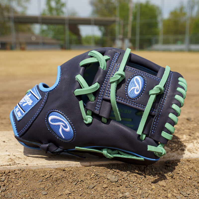 Picture of a navy exclusive Rawlings NXT Series 11.5" infield glove on a pitching rubber