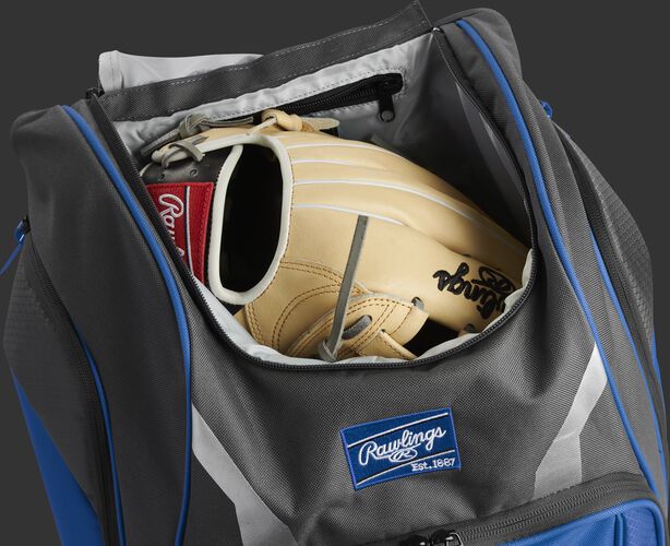 A glove in the dedicated glove storage pocket of a Rawlings Legion equipment backpack - SKU: LEGION-R