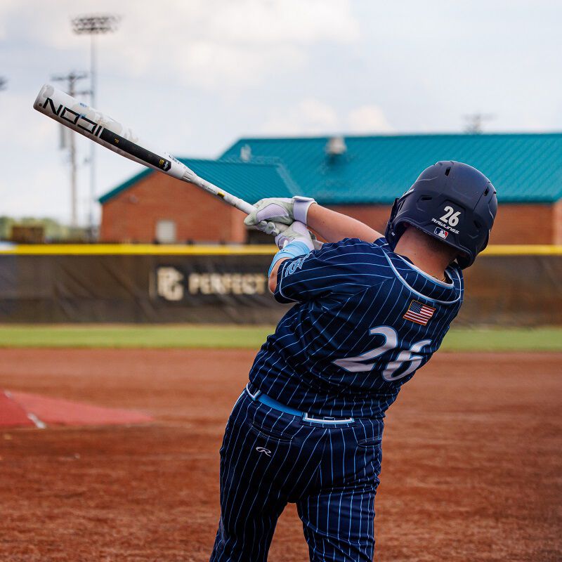 Picture from behind of a player hitting a ball with a 2025 Icon USSSA bat