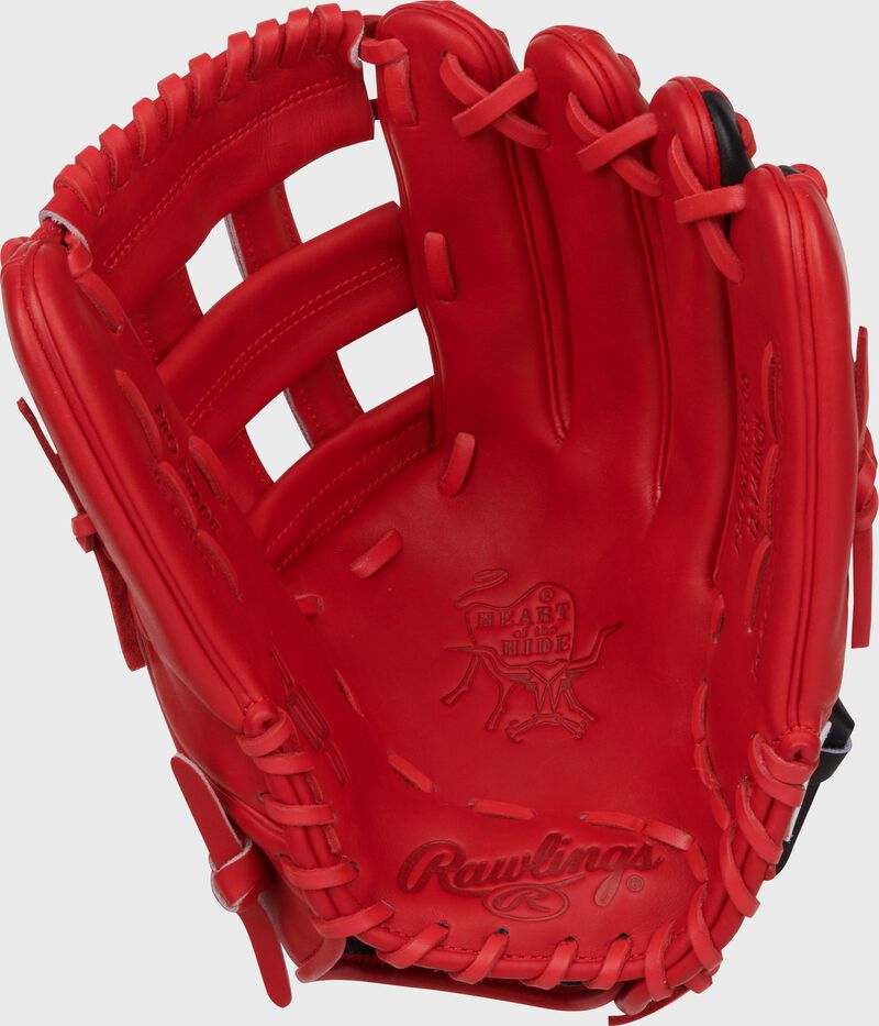 Scarlet palm of a Rawlings Corbin Carroll Heart of the Hide Outfield Glove with scarlet laces