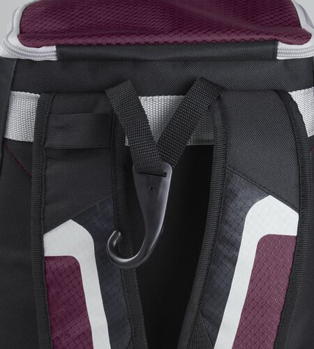 Exterior handle on the back of a black/maroon R500 backpack with a hook for hanging it up