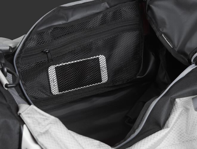 A phone inside the mesh accessory pocket inside the main compartment of a white R601 Hybrid bag