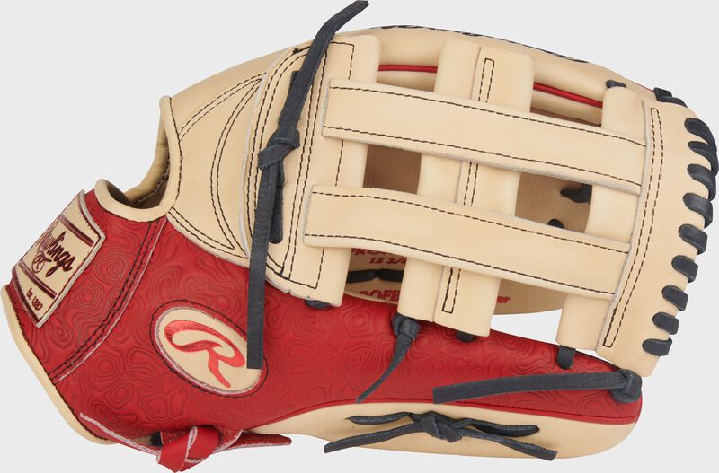 Scarlet thumb of a Rawlings Heart of the Hide 12.75-Inch Outfield Glove with a camel Pro H-web