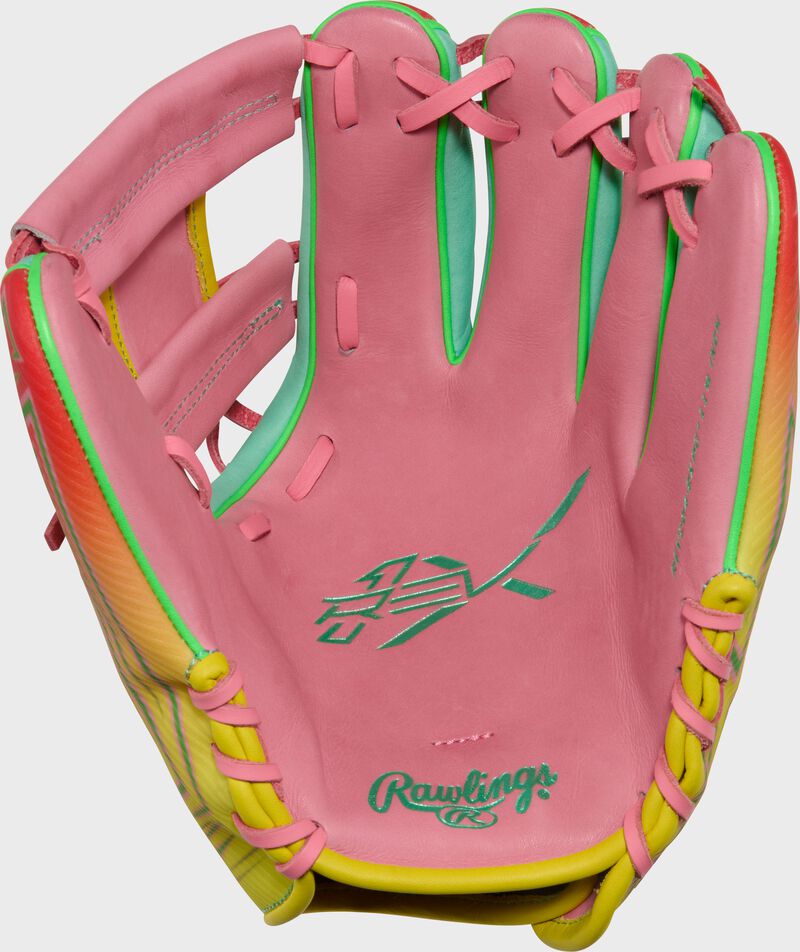 Pink palm of a Rawlings REV1X 11.5-inch infield glove with mint stamping and pink laces loading=