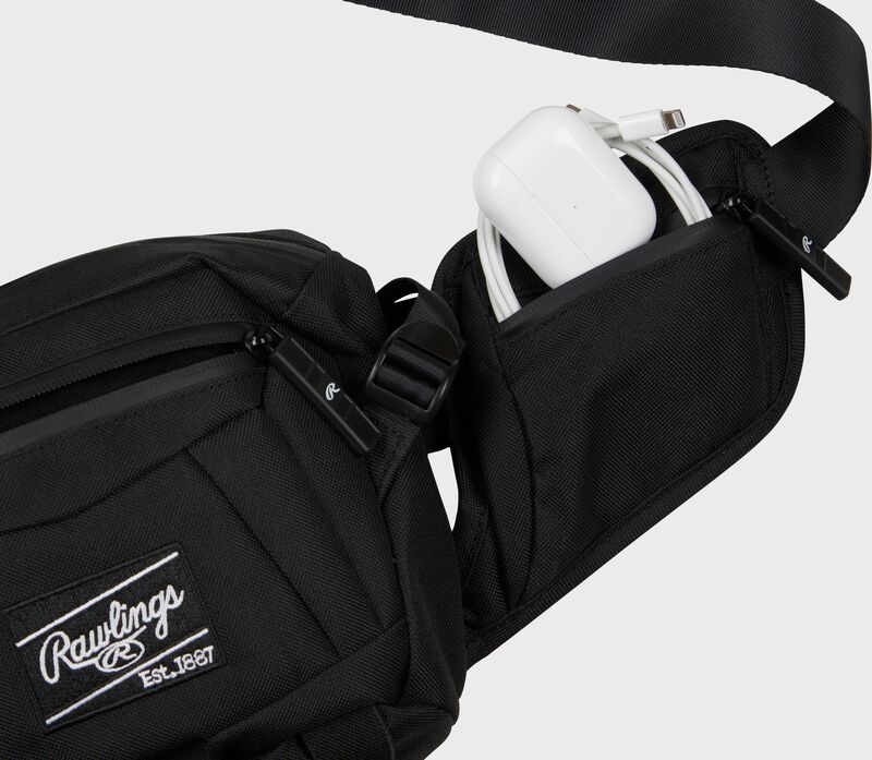 Side wing pocket of a players sling bag with a phone charger in the pocket - SKU: RSLING-BK