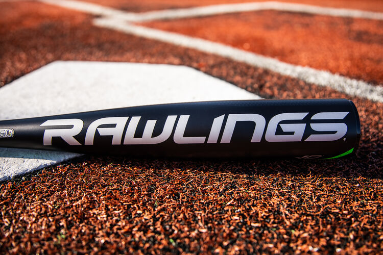 Rawlings logo on the barrel of a 2021 USSSA 5150 baseball bat laying on a field next to home plate - SKU: UT1510