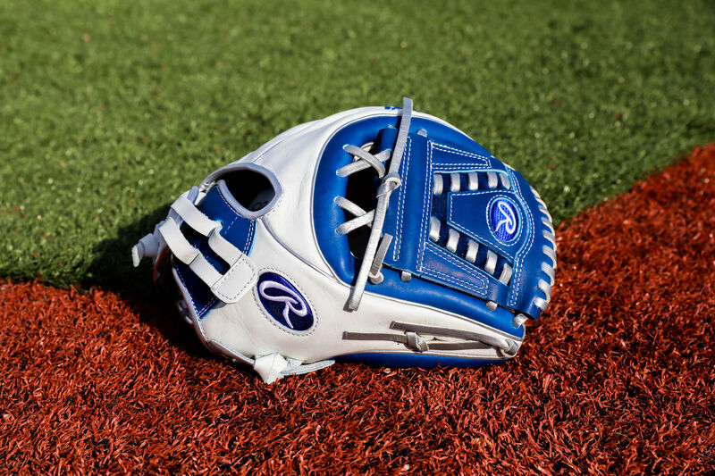 A white/royal Liberty Advanced Color Series 11.75-Inch infield glove with platinum laces on a field - SKU: RLA715SB-31WRP loading=