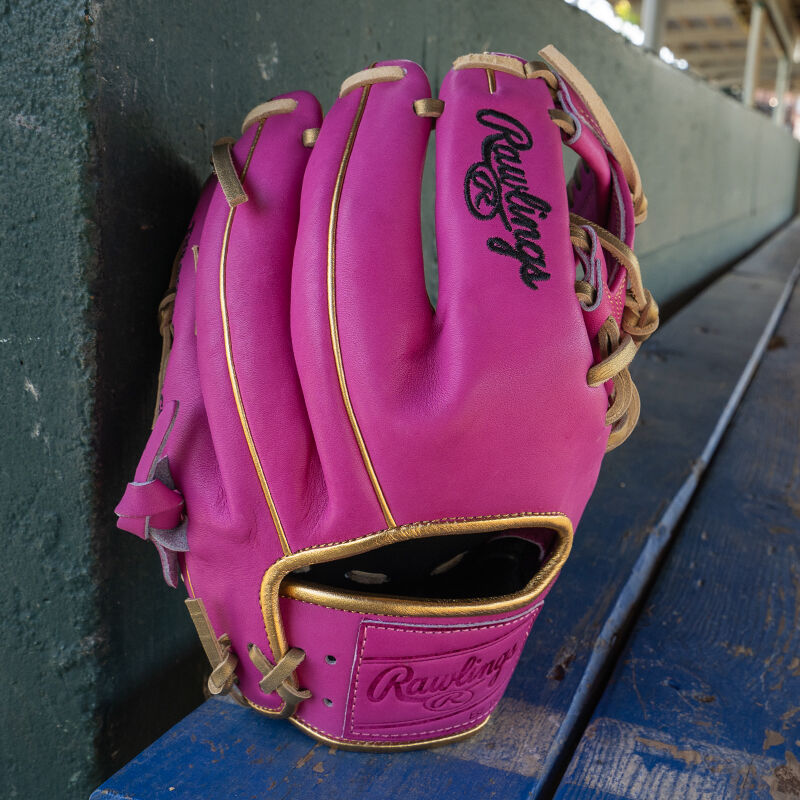 picture of an Exclusive 11.5" R2G Heart of the Hide Berry infield glove leaned against a wall