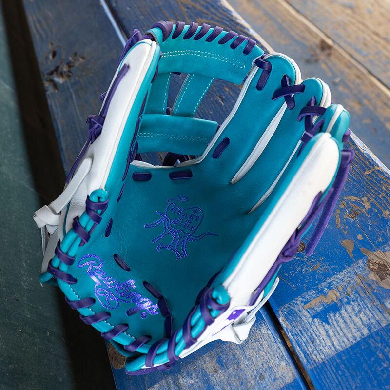 Picture of the teal palm of a Rawlings exclusive Heart of the Hide R2G Wing Tip 11.5" infield glove on a table