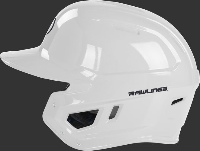 Left side of a white MCH01A Mach baseball helmet compatible with MEXT face guard extension