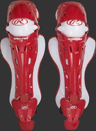 A pair of adult scarlet Rawlings Mach catcher's leg guards with white accents - SKU: MCHLGA-S