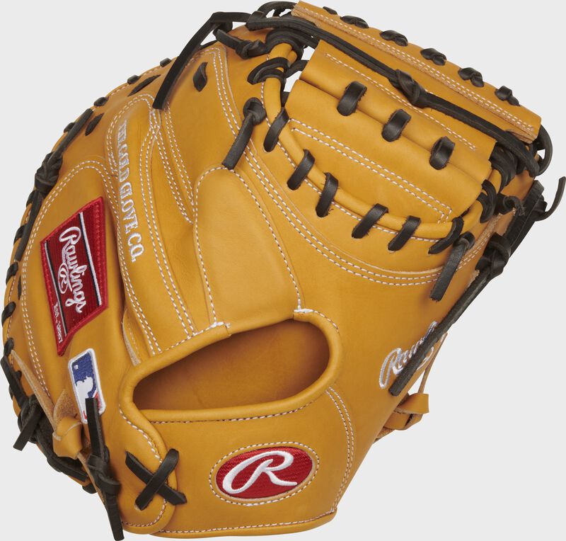 Back of a tan Heart of the Hide 33" catcher's mitt with a red Rawlings Oval-R on the wrist - SKU: PROTCM33T loading=