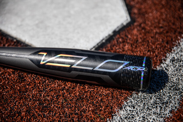 Grey/black barrel of a USA Velo ACP bat lying next to home plate - SKU: USZV10