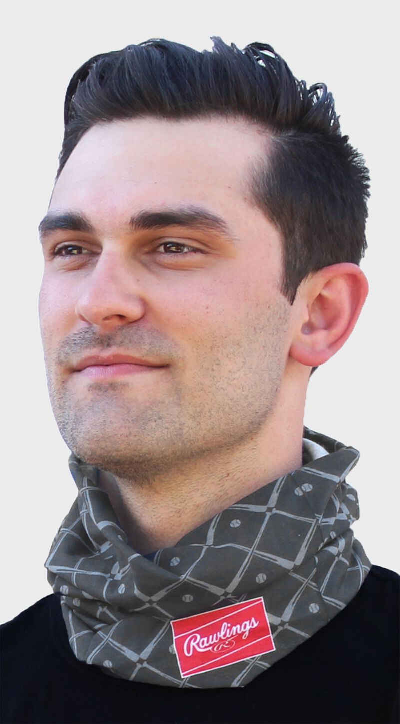 A guy wearing a graphite adult multi-functional neck gaiter around his neck - SKU: RC40005-005