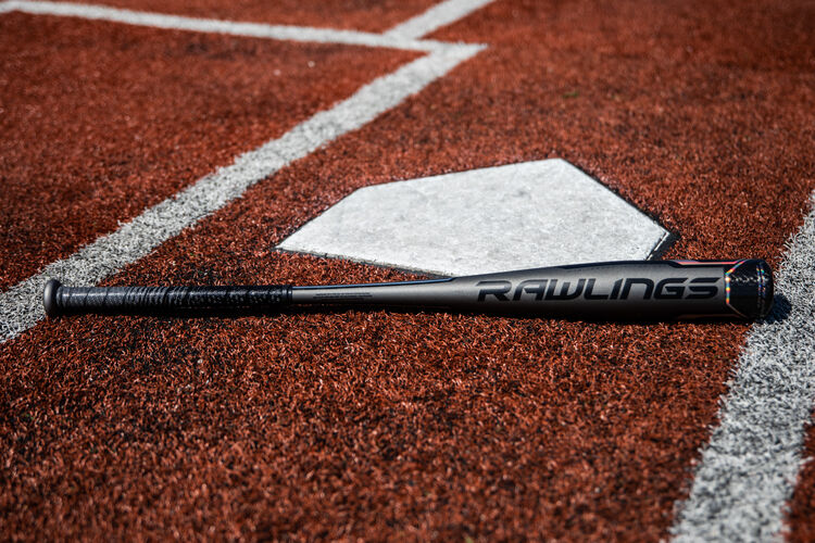 A Rawlings 2020 Velo ACP USA bat lying next to home plate - SKU: USZV5