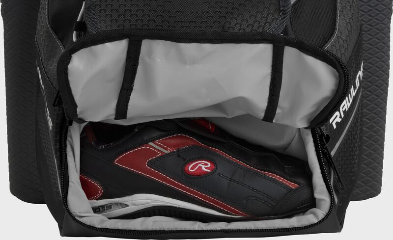 A black Rawlings baseball backpack with a cleat in the bottom cleat storage compartment - SKU: IMPLSE-B