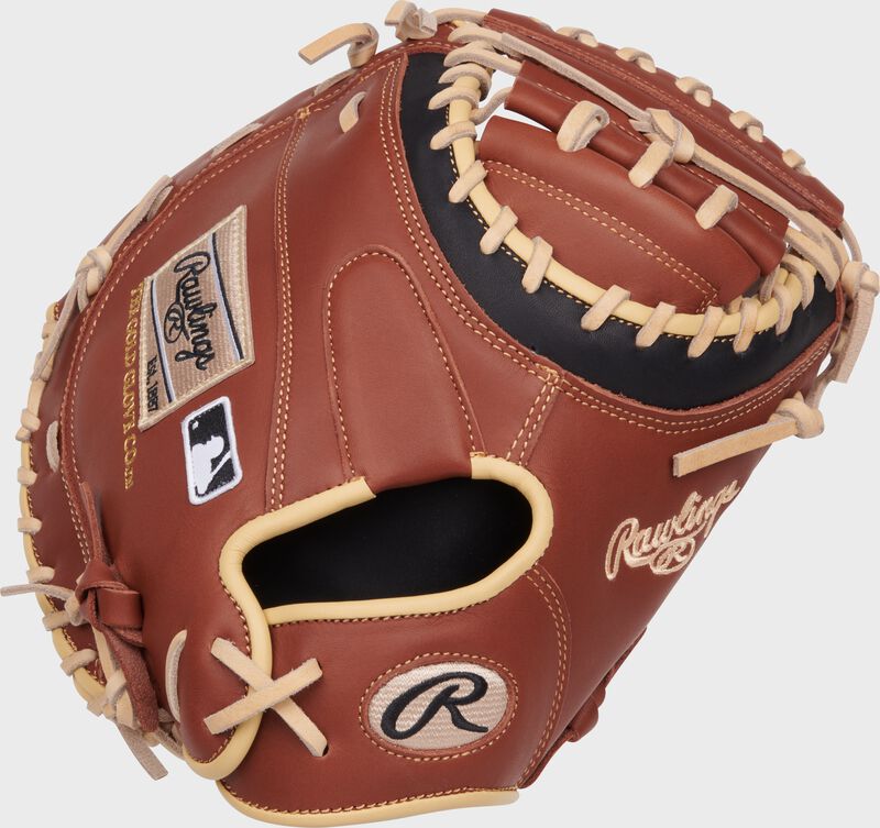 Back of a dark brown NXT Series 32.5" catcher's mitt with a tan Rawlings patch and Oval-R 