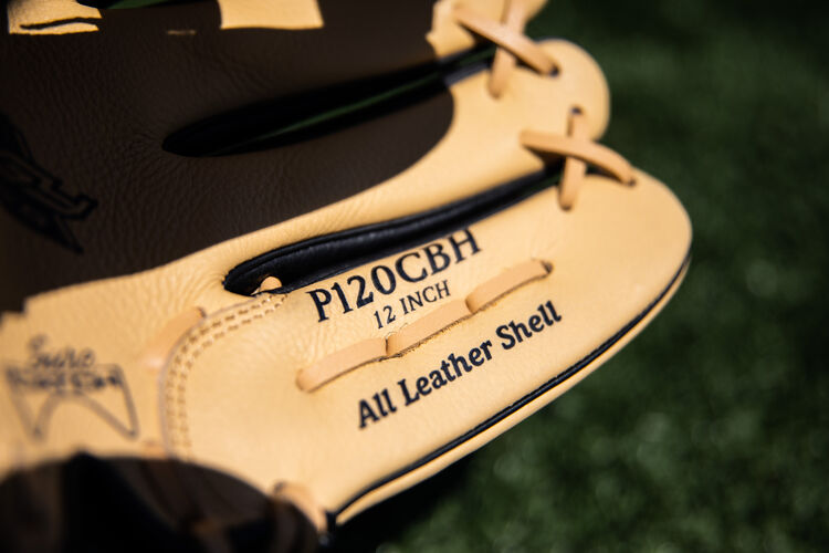 Camel pinkie on a Rawlings Prodigy youth glove lying on a field - SKU: P120CBH