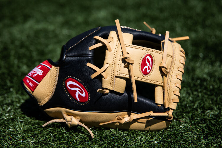 A Prodigy I-web infield glove lying on a field - SKU: P115CBI