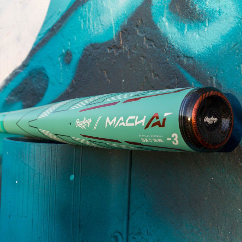 An ocean mint Rawlings Mach AI BBCOR bat in front of a painted wall - SKU: RBB4MC3