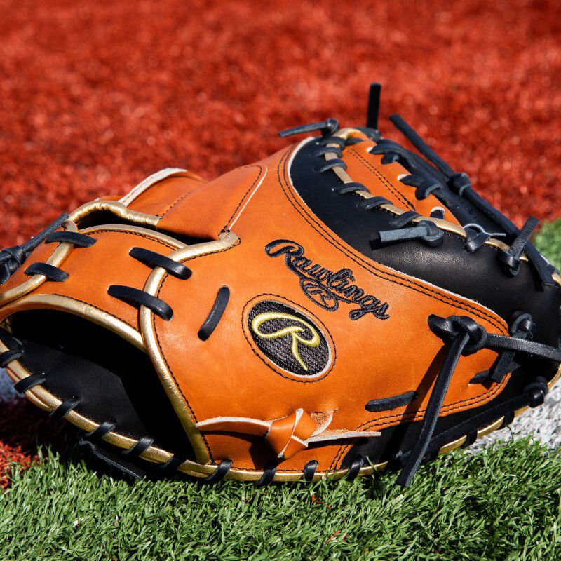 Back thumb of a golden brown ColorSync 8.0 Heart of the Hide catcher's mitt on a field
