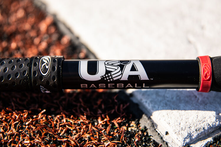 USA baseball stamp on the black handle of a Quatro Pro bat next to home plate - SKU: US1Q8